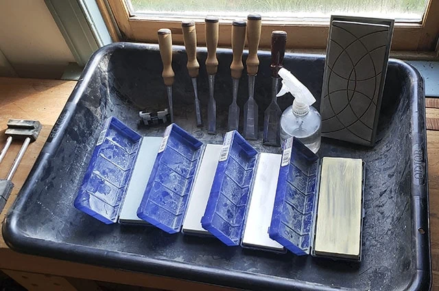 Norton Water Sharpening Stones With Wood Chisels For Chisel Sharpening In A Drywall Mud Tub