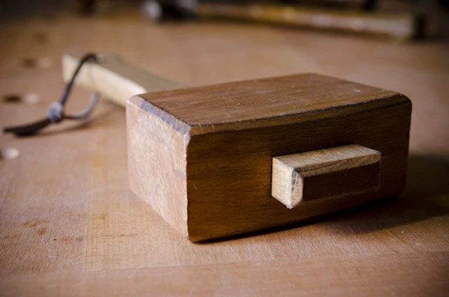 Wooden Joiner's Mallet Or Carpenter's Mallet On Workbench
