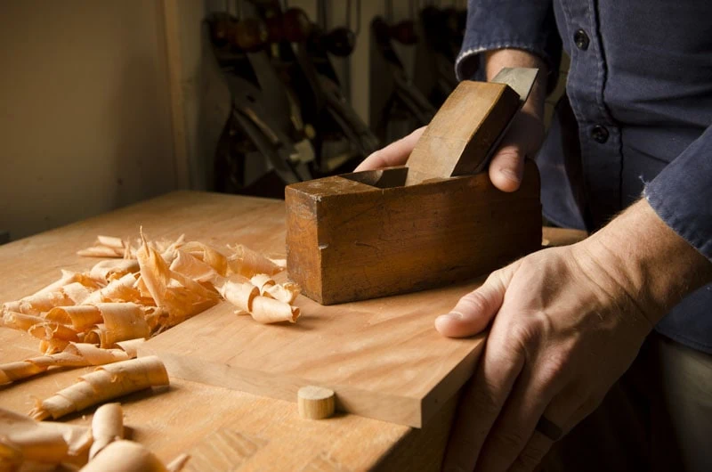 Hand Planing A Cherry Board With A Coffin Smoothing Plane Which Is A Woodworking Hand Tool