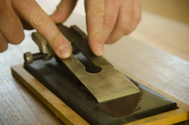 Man'S Hands Honing A Back Bevel On A Stanley Hand Plane Iron For High Angle Wood Figure Hand Planing
