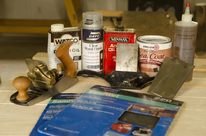Wood Finishing Products Including Scraper Plane, Sandpaper, And Wood Varnishes