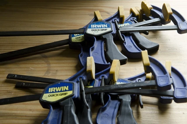 Irwin Quick Grip Wood Clamps Sitting On A Woodworking Workbench