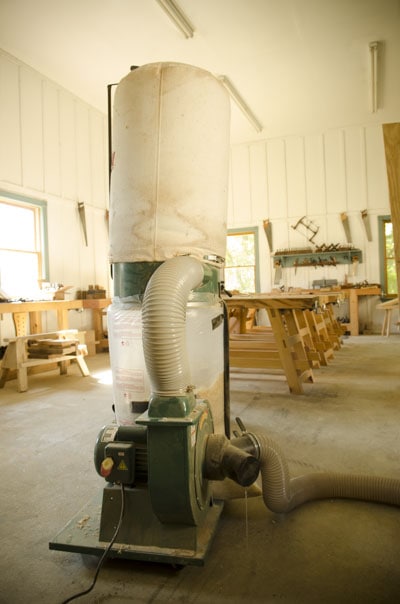 Grizzly G1028Z2 1-1/2 Hp Dust Collector In A Woodworking Workshop With Moravian Workbenches In The Background