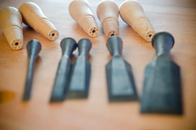 Stanley Chisel Set Handles In Focus On A Woodworking Workbench With Antique Socket Chisels Blurred In The Foreground Best Wood Chisel Guide