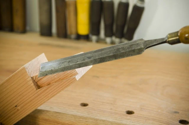 Using An Antique Paring Chisel To Make A Sliding Tapered Dovetail Joint On A Woodworking Workbench Top