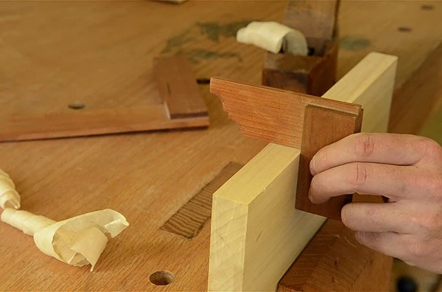 Using A Wooden Try Square To Square The Edge Of A Board