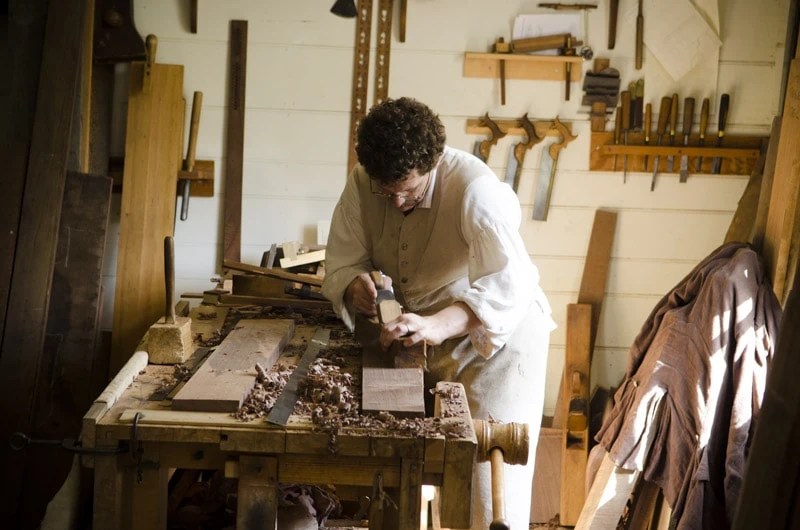 Brian Weldy Hand Planing A Board At The Colonial Williamsburg Hay Cabinet Wood Shop On A Wood Work Bench