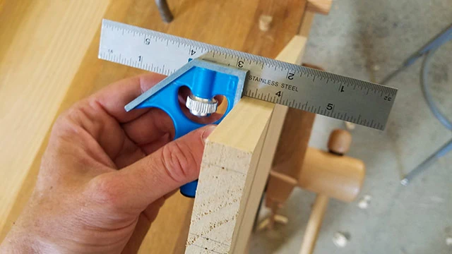 Blue Metal Combination Square Checking The Squareness Of A Board For Woodworking