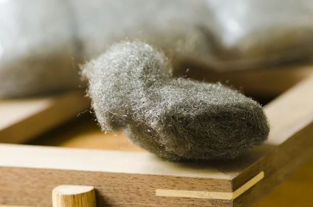 Steel Wool Sitting On A Walnut Picture Frame With A Miter Spline
