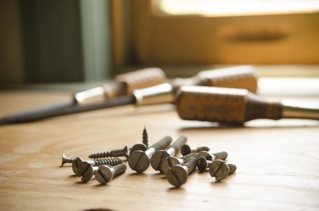 Grace Brand Screwdrivers Sitting On A Woodworking Workbench With Historical Style Slotted Screws