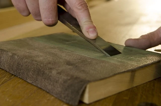 Stropping A Woodworking Wood Chisel On A Leather Stop For Chisel Sharpening